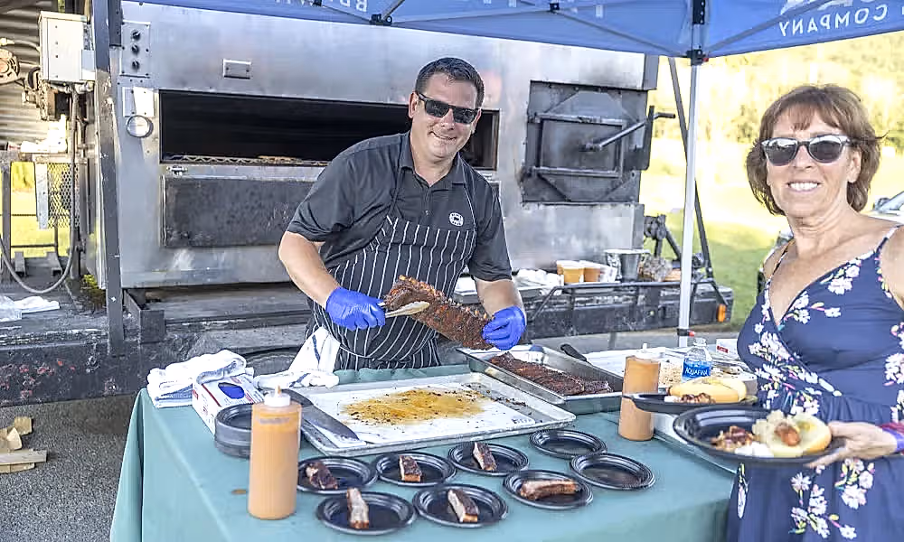 Chef cooking ribs at BBQ. 